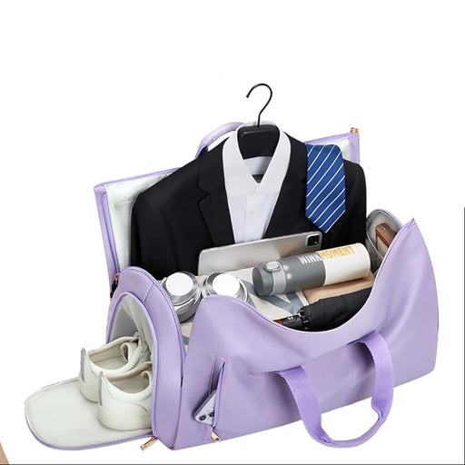 Purple travel bag with a suit, shoes, and other items on a white background