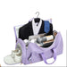 Purple travel bag with a suit, shoes, and other items on a white background